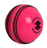 The Gray Nicolls Wonderball is a bright pink cricket training ball featuring black stitching, the Gray Nicolls logo, and printed text—perfect for catching practice.
