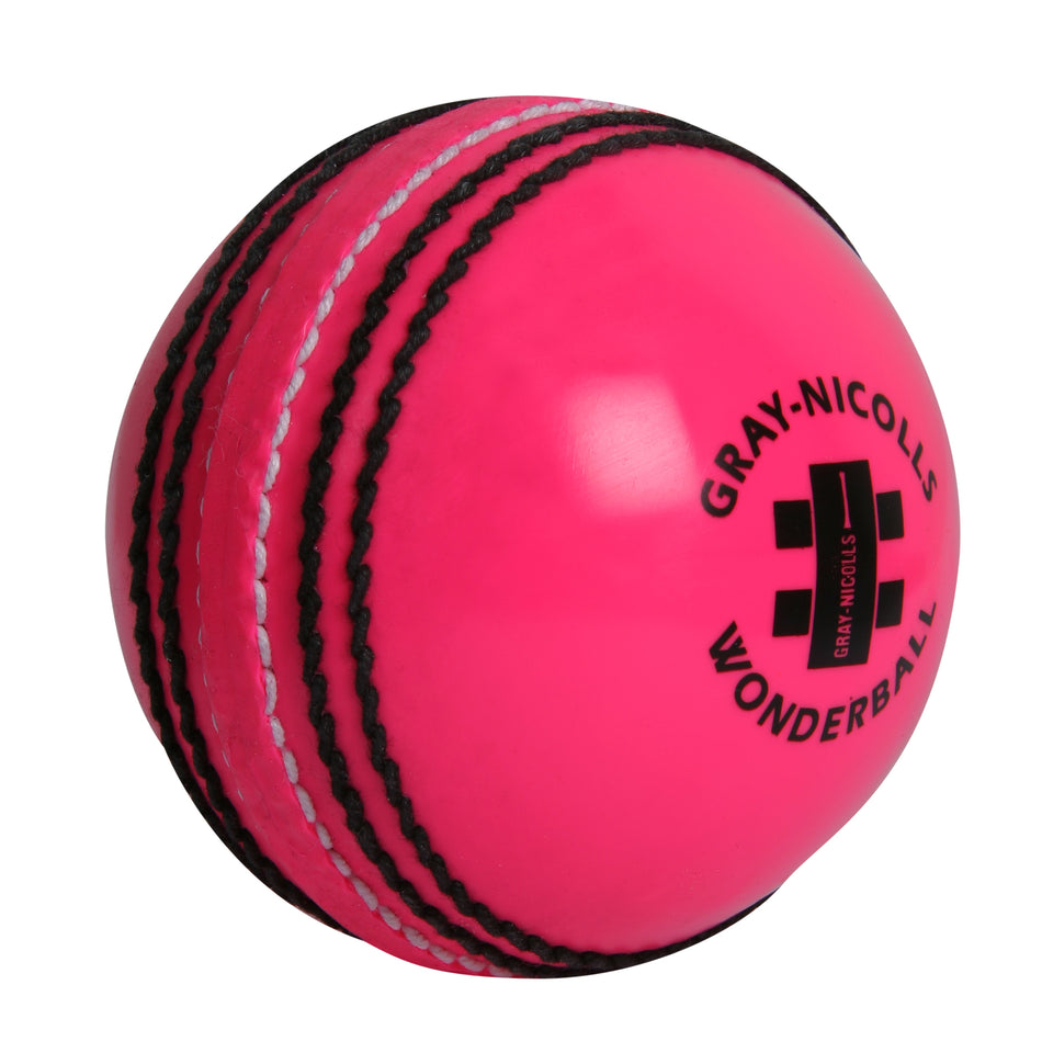 The Gray Nicolls Wonderball is a bright pink cricket training ball featuring black stitching, the Gray Nicolls logo, and printed text—perfect for catching practice.