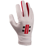 The Gray Nicolls Pro Full Finger Batting Inners are crafted from premium soft cotton, featuring a white design with a red stripe between the middle and ring fingers, plus a red and black Gray Nicolls logo on the back.