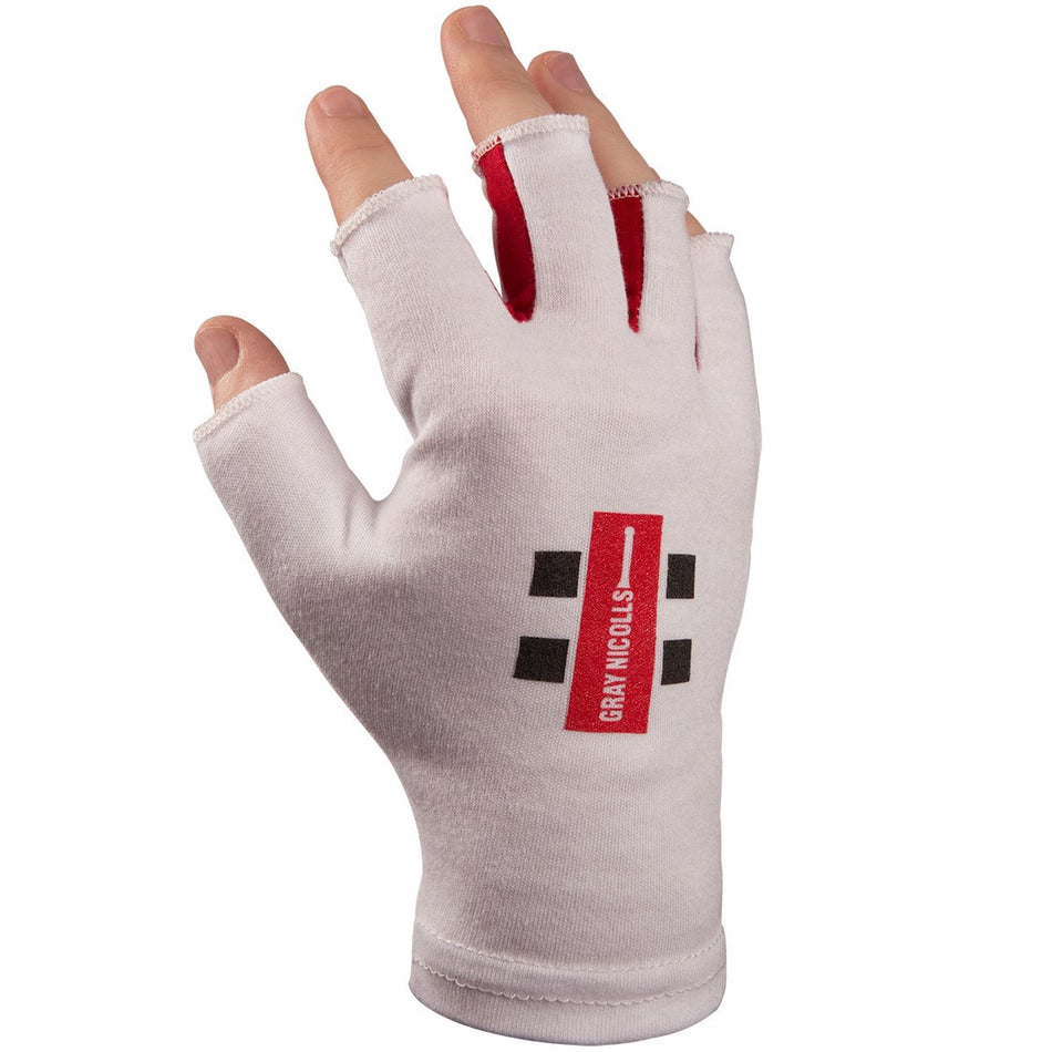 A hand wears a premium cotton, white fingerless glove featuring red and black rectangles and "GRAN KNUCKS" text. Similar to the Gray Nicolls Pro Fingerless Inners by Gray Nicolls, it leaves fingertips and the thumb exposed.