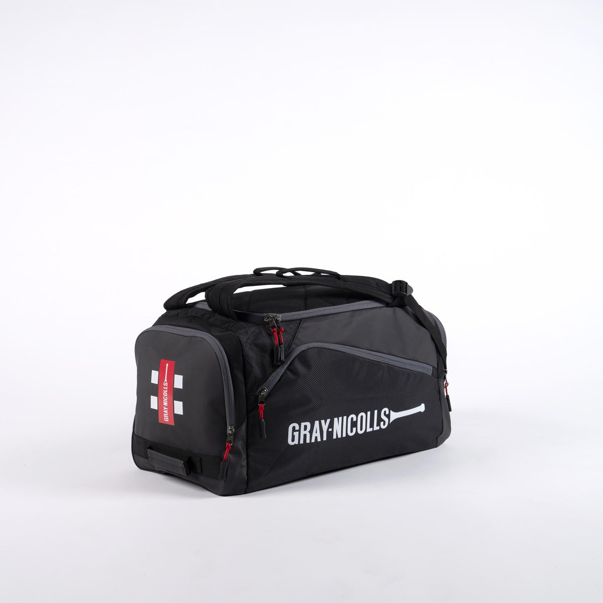 The Gray Nicolls Team Holdall 2026 is a black match day bag with red zippers, a side shoe pocket, and a white Gray Nicolls logo with cricket bat icon on the main side, displayed against a plain white background.