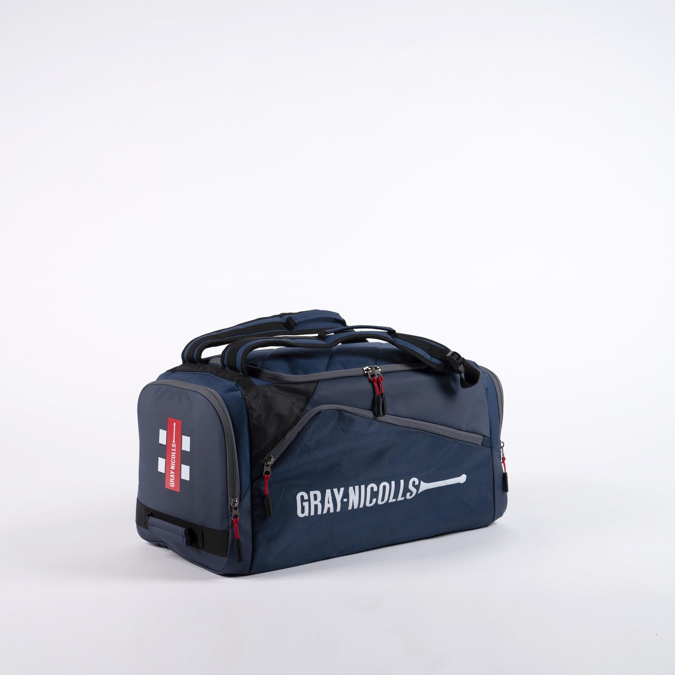 The Gray Nicolls Team Holdall 2026 is a navy sports duffle bag with black and red accents, branded with the Gray Nicolls logo. It features multiple zippered compartments, a shoe pocket, and padded handles for comfortable carrying.