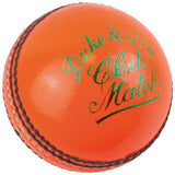 The Dukes Club Match A Cricket Ball (Senior - Orange) features a bright orange leather surface, black stitched seams, and green "Duke & Son Club Match" text. Brand: Dukes.