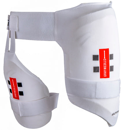 The Gray Nicolls Academy All In One junior cricket thigh pad combines a white, padded design with attached inner thigh protection, adjustable straps, dual level protection, and red and black Gray Nicolls branding for superior leg safety.