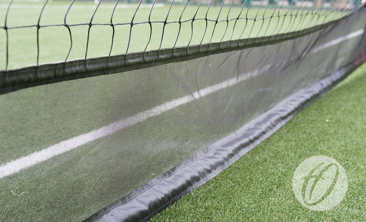Close-up of Harrod Sport Braided Cricket Netting - 3.6M High W/ Vermin Skirt, showing durable mesh similar to tennis nets, with a white line and optional vermin skirt for extra protection.