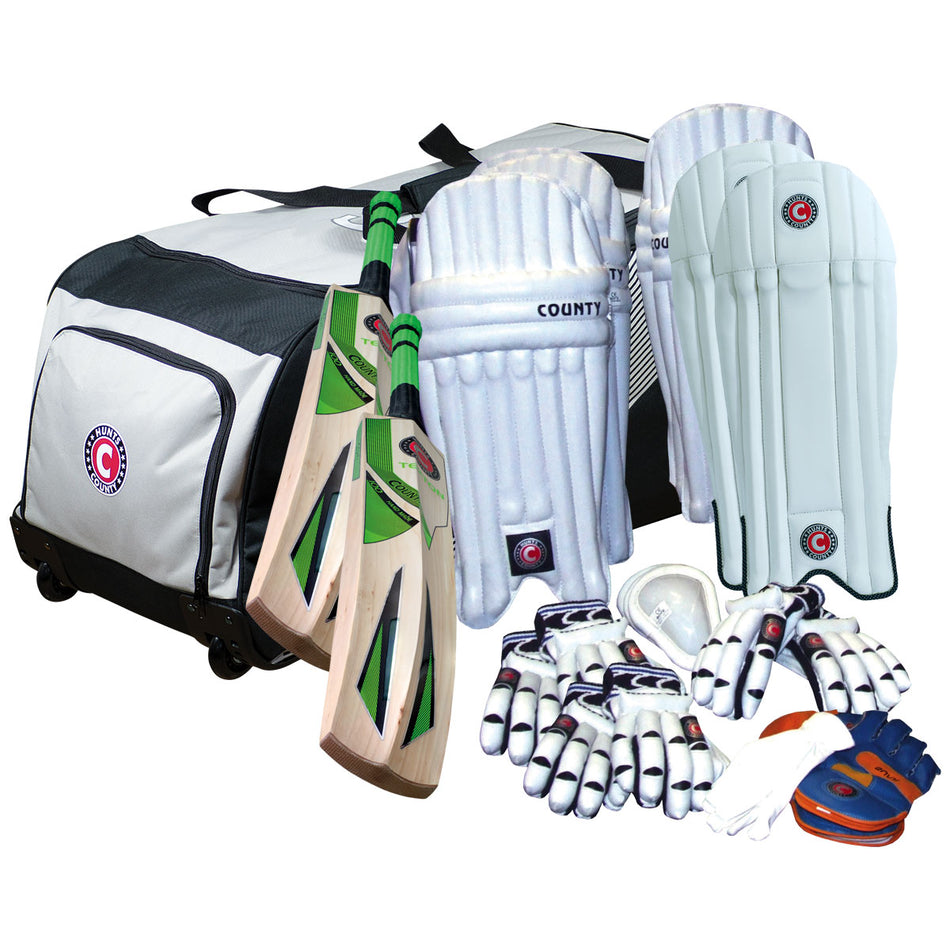 A Hunts County Senior Team Kit Bag with Hunts County bats, two pairs of batting pads, gloves, arm guards, a thigh guard, and an orange-blue wicketkeeping glove—neatly arranged on a white background.