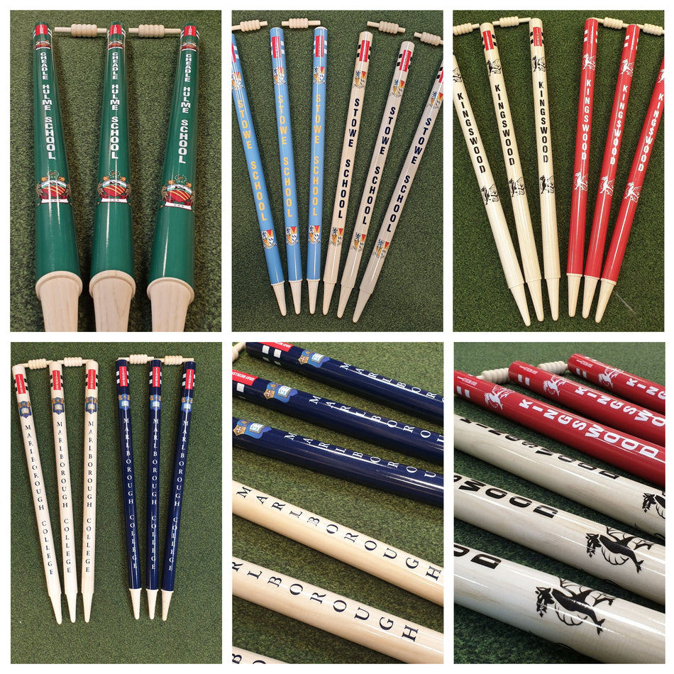 A collage of six photos features Gray Nicolls Custom Printed International Cricket Stumps, each set painted in various colors with team or club names, arranged in threes on a green field.