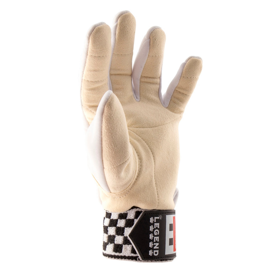 A tan Gray Nicolls Legend XRD Wicket Keeping Inner with white accents, shown upright with bent fingers and a black-and-white checkered wrist strap labeled LEGEND, similar to classic Gray Nicolls styling.