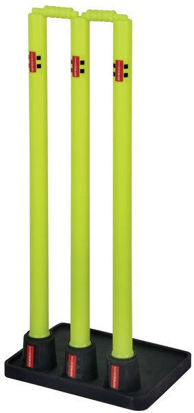 Three bright yellow Gray Nicolls Rubber Based Stumps are mounted on a black rectangular base, each featuring small red and black Gray Nicolls labels near the bottom.