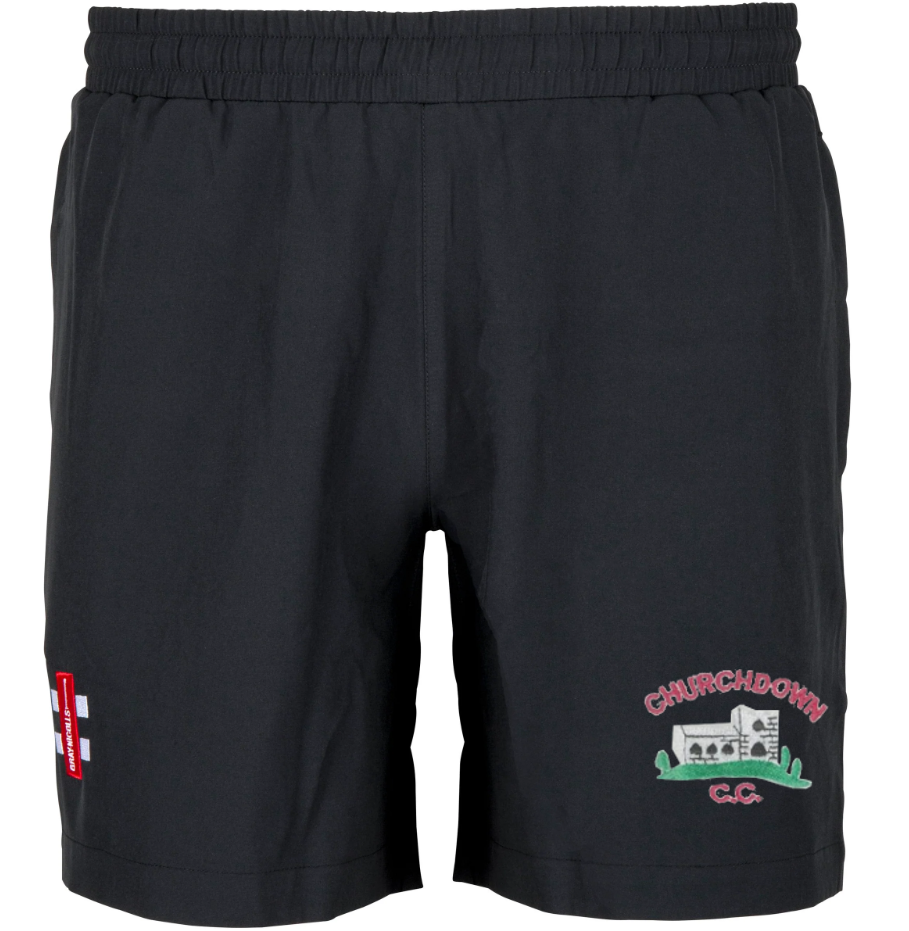 Gray Nicolls Churchdown CC Velocity Shorts feature an elastic waistband, embroidered Churchdown C.C. logo, and a red and white patch on the front. These premium black cricket shorts are displayed against a white background.