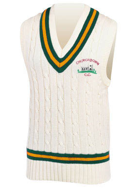 The Martin Berrill Sports Churchdown CC Short Sleeve Slipover is a white cable-knit cricket jumper with green and yellow striped V-neck and hem, featuring the embroidered Churchdown CC logo with a cricket image on the left chest.