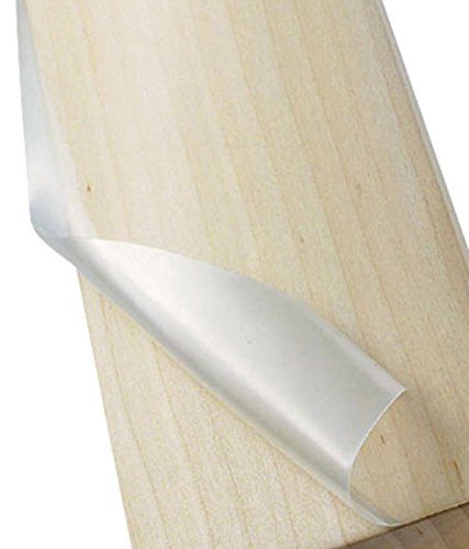 A close-up of the Martin Berrill Sports Professional Cricket Bat Anti-Scuff Sheet - Players Grade, partially peeled from a light wooden bat, showcases its transparent film—perfect for superior protection and players grade performance.