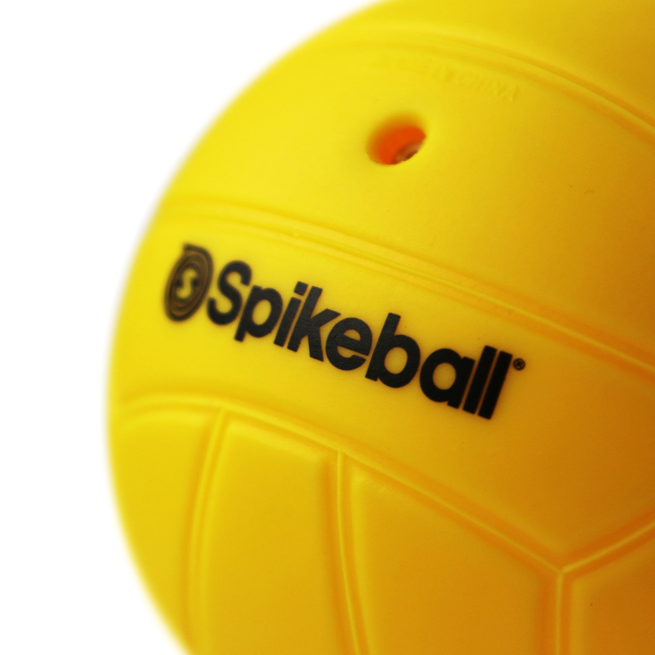Close-up of a bright yellow ball from the Kankakee Spikeball Standard Replacement Balls (2 Pack), featuring bold black “Spikeball” branding and a small circular hole near the top—ideal for replacing worn out balls in your set.