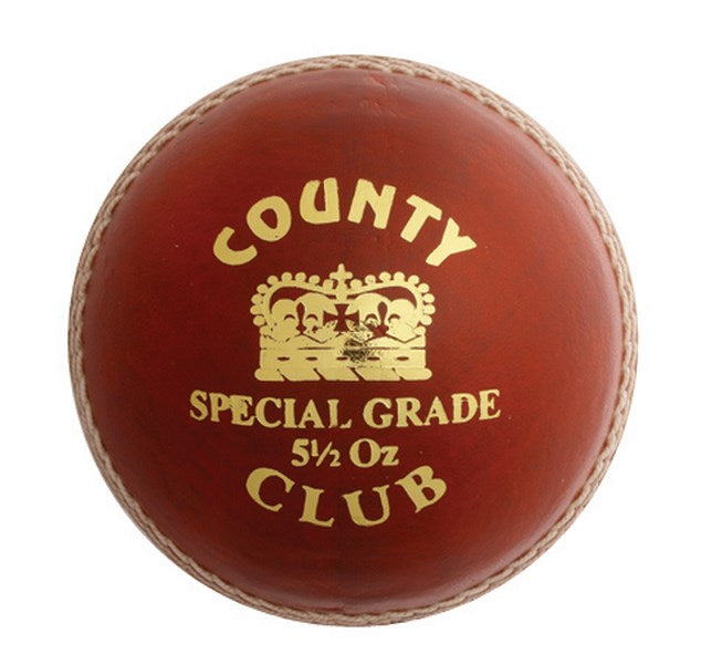 A red leather Hunts County Club Cricket Ball by Hunts County, with white stitching, gold text reading COUNTY CLUB SPECIAL GRADE 5½ OZ, and a crown image in the center.