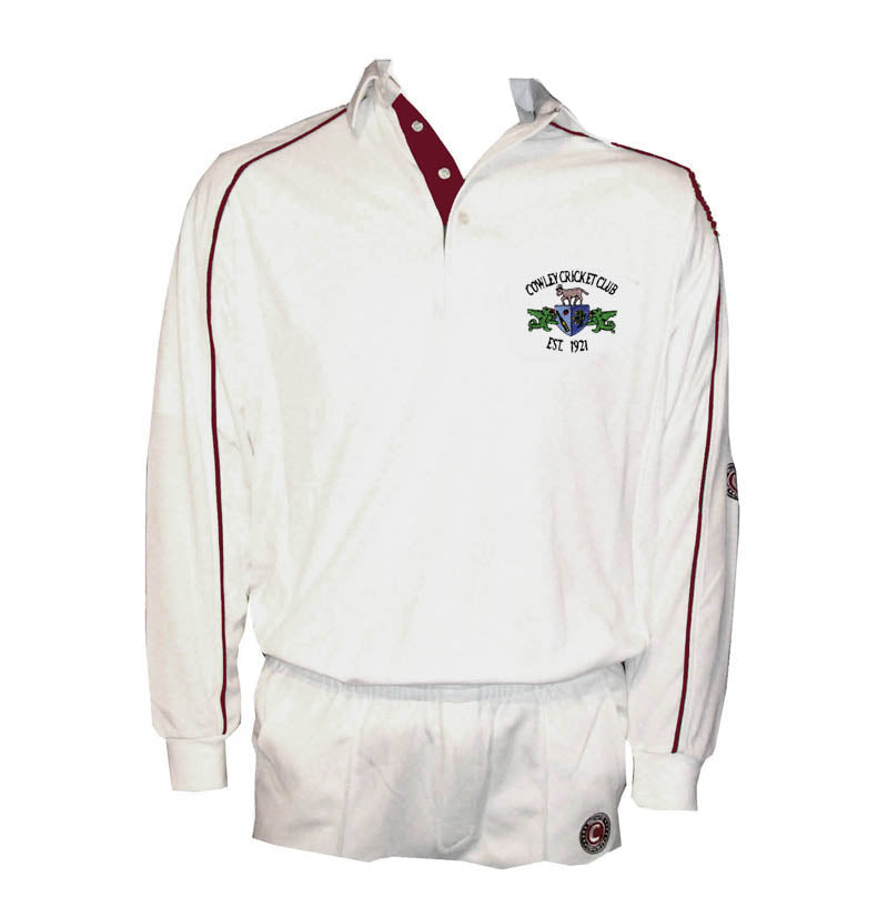 The Martin Berrill Sports Cowley CC Long Sleeve Cricket Shirt is a white, collared top with red piping, buttons, active wick-away fabric, and an embroidered World Cricket Club EST. 1971 logo. Includes matching white trousers.