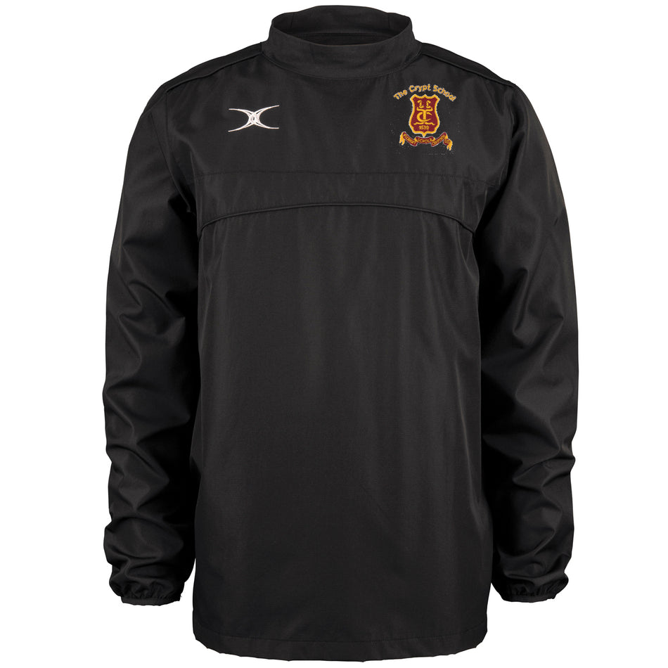 The Gilbert Crypt School Black Photon Warm Up Top is a lightweight long-sleeve training top with an embroidered crest on the left chest, white Gilbert logo on the right, elastic cuffs, and a sleek design without front zippers or buttons.