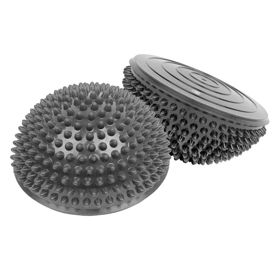 The Fitness Mad Balance Pod Dome (Pair) by Fitness Mad features two gray pods with textured tops and smooth bottoms, ideal for improving balance, building core strength, and enhancing fitness or physical therapy routines.