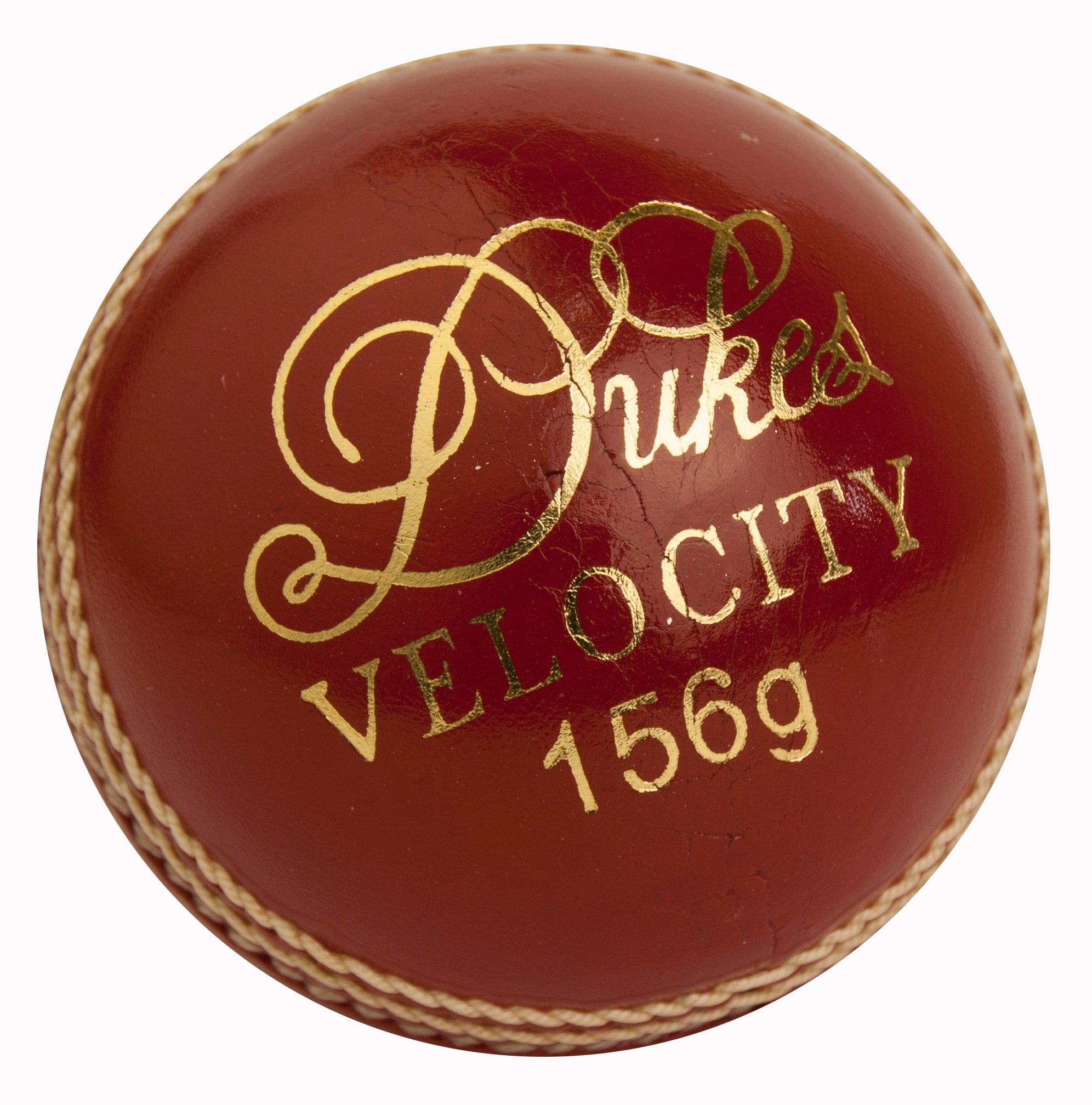 A red Dukes Velocity Senior Cricket Ball with gold "Dukes VELOCITY 156g" text and visible seam stitching.