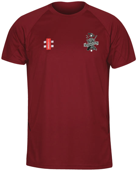 The Eastcombe CC Matrix V2 T Shirt by Gray Nicolls is a maroon top with a white and red rectangular logo on the left chest and an embroidered club crest on the right, designed for comfort and excellent moisture management.