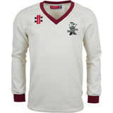 The Gray Nicolls Eastcombe CC Pro Performance Sweater is a white, long-sleeved cricket sweater with maroon cuffs and V-neck, featuring black and red chest logos and an "Eastdale" crest on the left side.