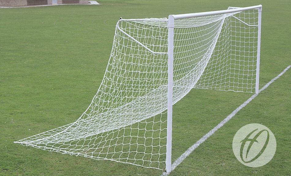 The Harrod Sport Super Heavyweight Goal, Locking Sockets - Junior stands on a lush green field. A white H logo on the lower right highlights the steel posts' exceptional durability and welded crossbar construction.