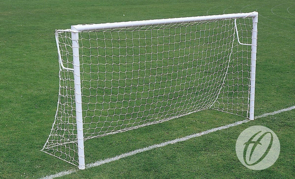 A Harrod Sport Super Heavyweight Goal Locking Socket (7v7/5v5) soccer goal with net, featuring welded crossbar and steel posts, stands on a green grass field near a white sideline.
