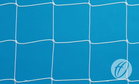 A close-up of a white net with square patterns against a solid blue background, showcasing the durability of the Harrod Sport 2.5mm Poly Polygoal Net - 7v7/5v5. There is a circular logo with the letter H in the bottom right corner.