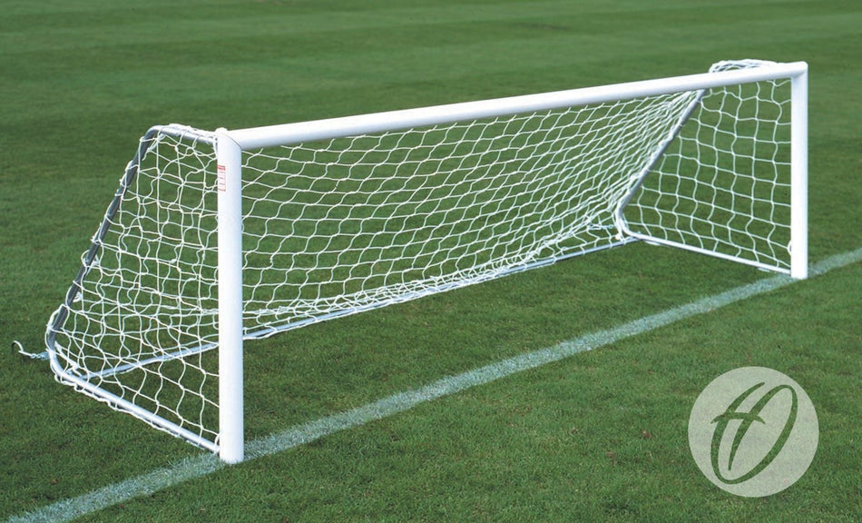 A Harrod Sport Folding Aluminium Football Goal (2.44m x 1.22m) with netting stands on a grassy field, positioned along a white boundary line.