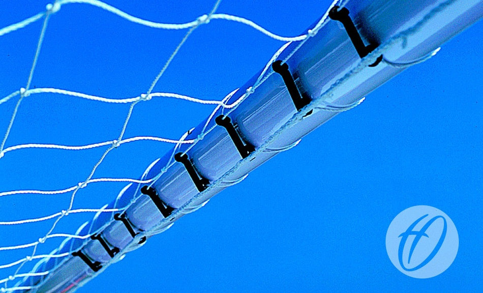 A close-up view of a volleyball net fastened with Harrod Sport Plastic Net Clips (80 pack), featuring the FBL-225 model set against a clear blue sky, with a partial Harrod Sport logo visible in the bottom right corner.