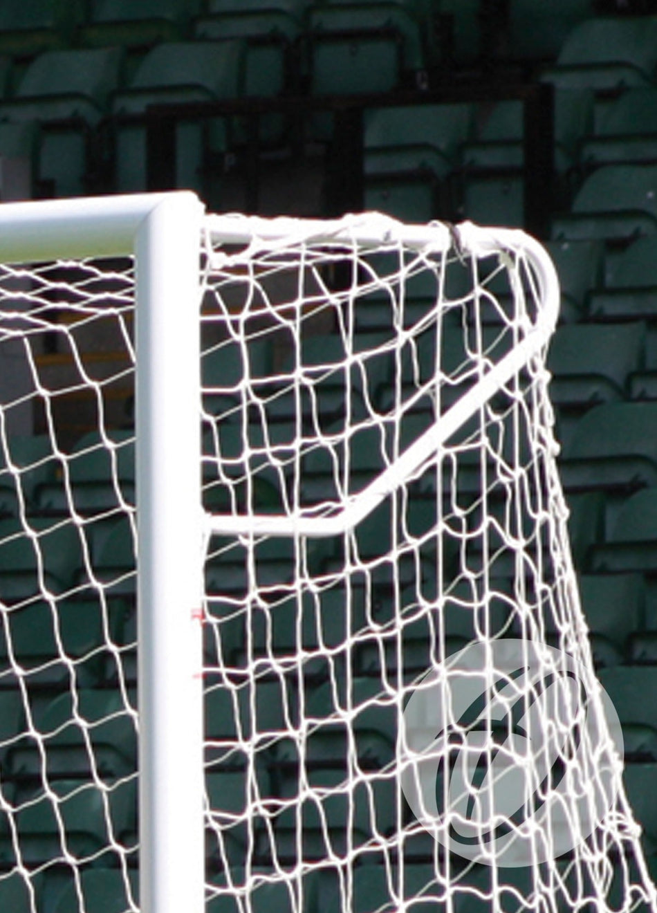 Close-up of Harrod Sport’s Elbow Net Support for 3G Stadium Club Goal, highlighting robust aluminium brackets and net, with empty green stadium seats in the background.