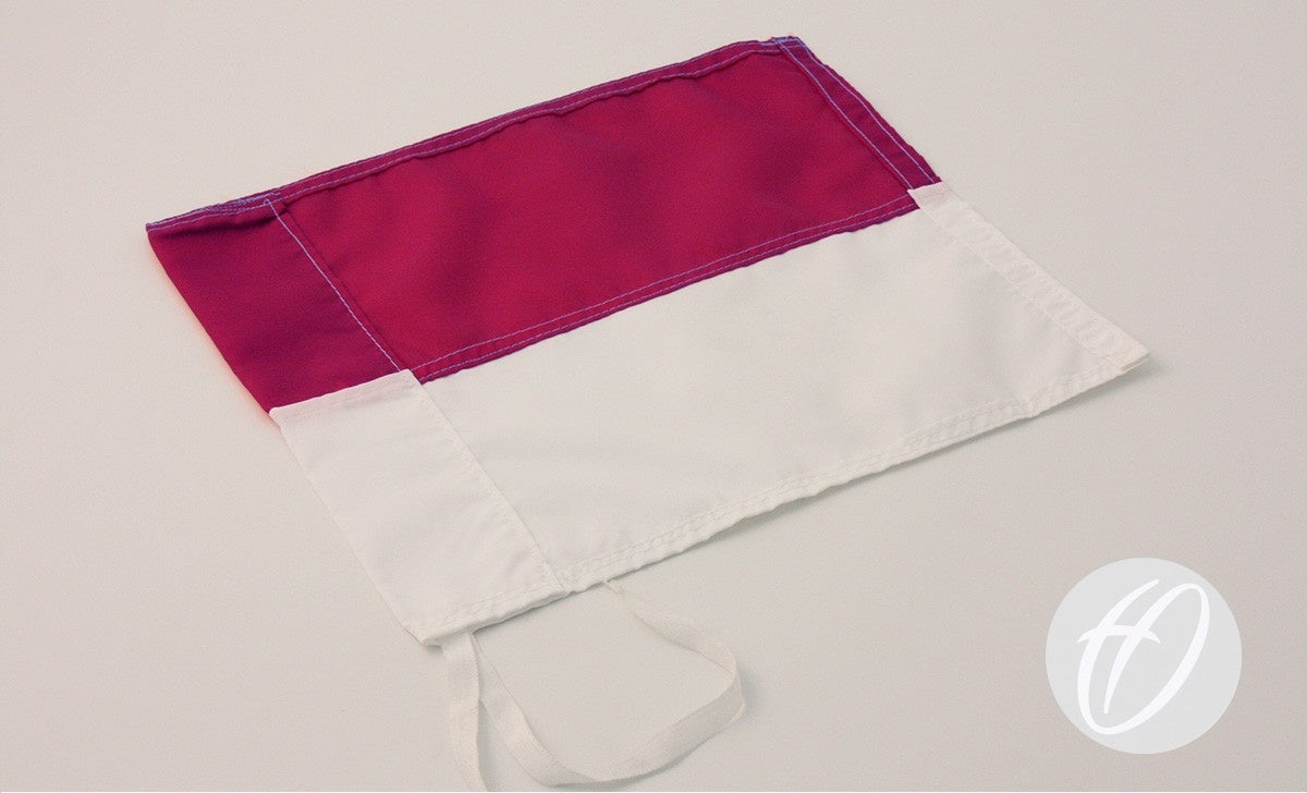 The Harrod Sport Maroon & White Horizontal Flag, 30cm x 30cm, features a maroon top and white bottom, lies flat on a white surface and has two side ties for easy attachment as a corner pole flag.