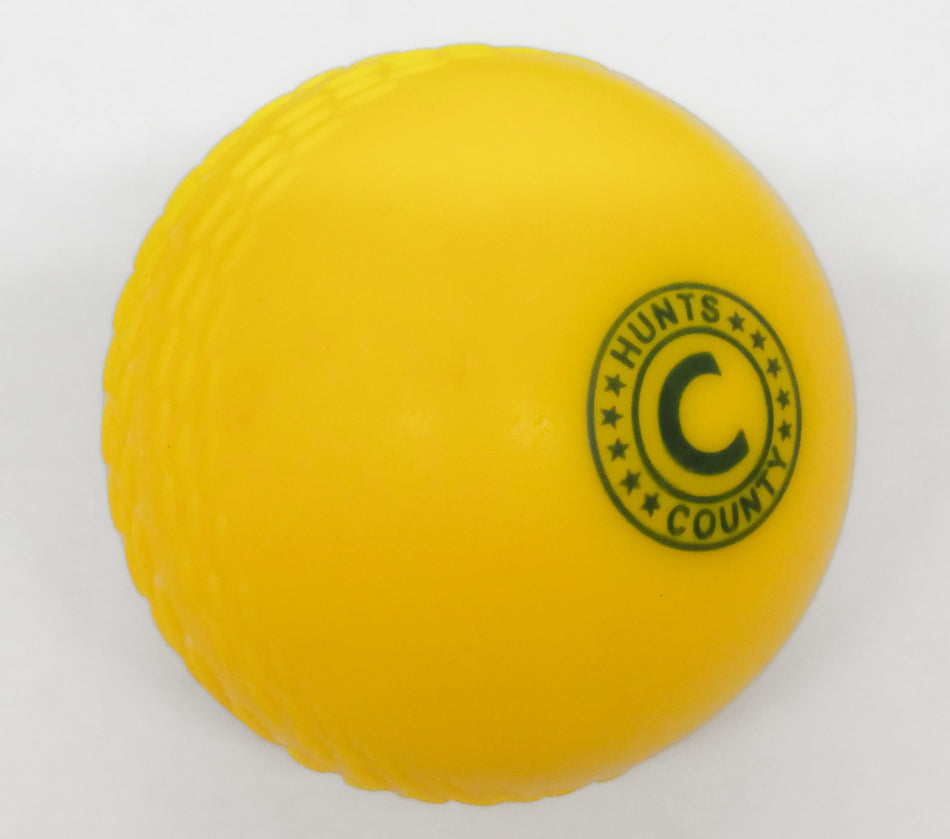 The Hunts County Flik Cricket Set (Half) features a bright yellow practice ball with a textured seam and green logo, ideal for use with plastic cricket bats or as part of any junior cricket kit from Hunts County.