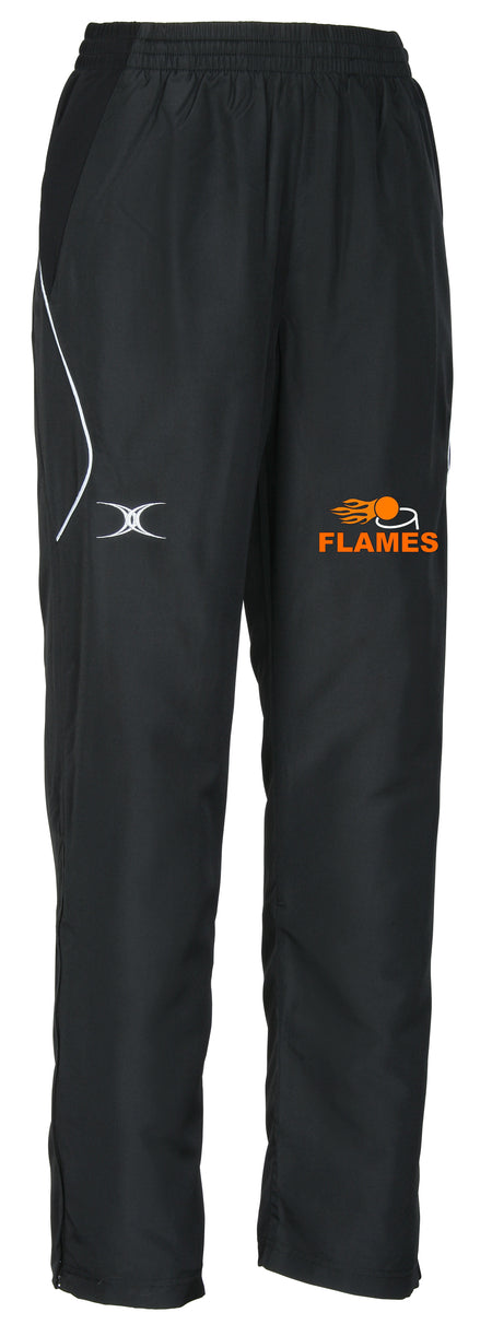 The Flames Netball Club Gilbert Blaze Track Trouser by Gilbert features black fabric, white detailing, an embroidered white logo on the left thigh, and an orange FLAMES logo with flame graphic—ideal for club fans or athletic wear.