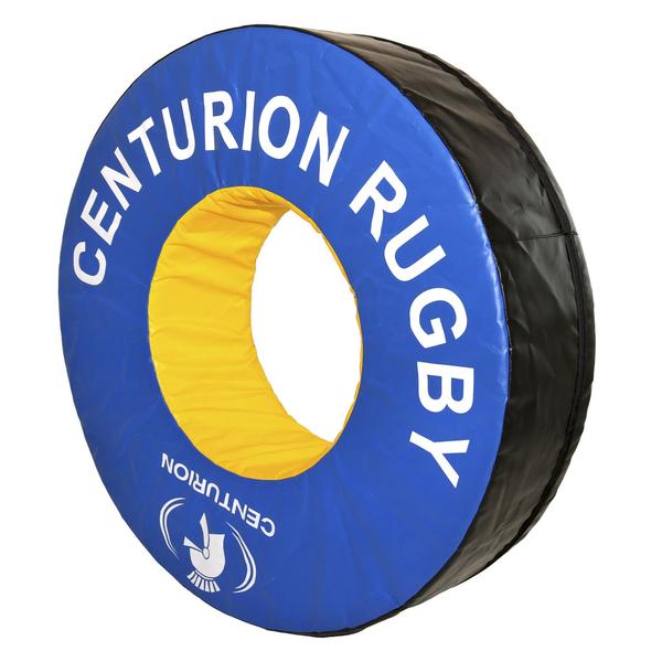 The Centurion Foam Tackle Ring (Doughnut) is a large, round blue and yellow padded tackle aid with CENTURION branding and logo, featuring a yellow inner circle, blue outer ring, and black sides—ideal for safe rugby training.
