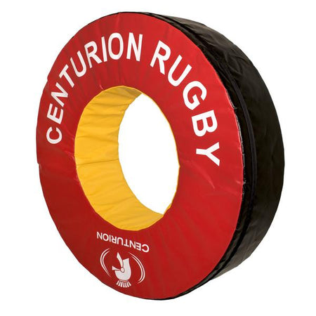 The Centurion Foam Tackle Ring (Doughnut) is a large circular red and black rugby training ring with a yellow center, branded with CENTURION RUGBY and the logo in white—perfect for safe tackling practice sessions.