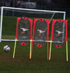 Three Precision Training Folding Free Kick Men in red and yellow are set up on a grassy field near a goal with a soccer ball, making them ideal football training equipment.