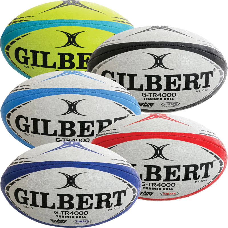 Five Gilbert G-TR4000 Rugby Balls by Gilbert in yellow, grey, blue, white/blue, and white/red; each has Tri Grip Technology for better handling, textured panels for training, and features a black logo.