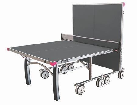 The Butterfly Garden Rollaway 6000 Outdoor Table Tennis Table (Grey) features a 6mm melamine top, wheels, and a net. Shown partially folded with one half upright for solo play. Brand: Butterfly.