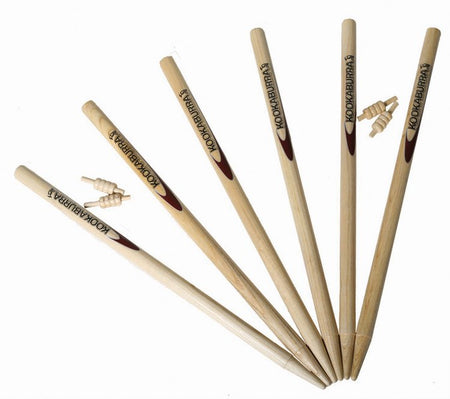 Six wooden Kookaburra Pro Stumps by Kookaburra, arranged in a fan shape with two bails atop, displayed on a white background, exemplify professional cricket stumps made to MCC standards.