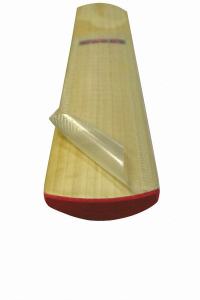 A close-up of a Kookaburra cricket bat with a Kookaburra Armourtec Anti Scuff Sheet partially peeled off, revealing smooth wood beneath. The bat's red edge highlights essential protection from the trusted Kookaburra brand.