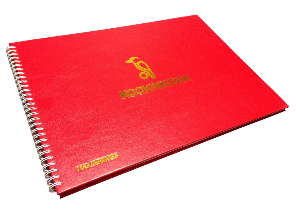 The Kookaburra Wirebound 100 Innings Scorebook is red, with a gold bird logo and "100 INNINGS" printed in the bottom left corner.
