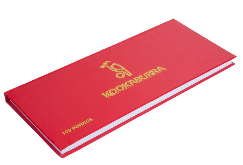 A red hardcover Kookaburra 100 innings Scorebook, featuring gold KOOKABURRA branding on the front, is shown against a white background.