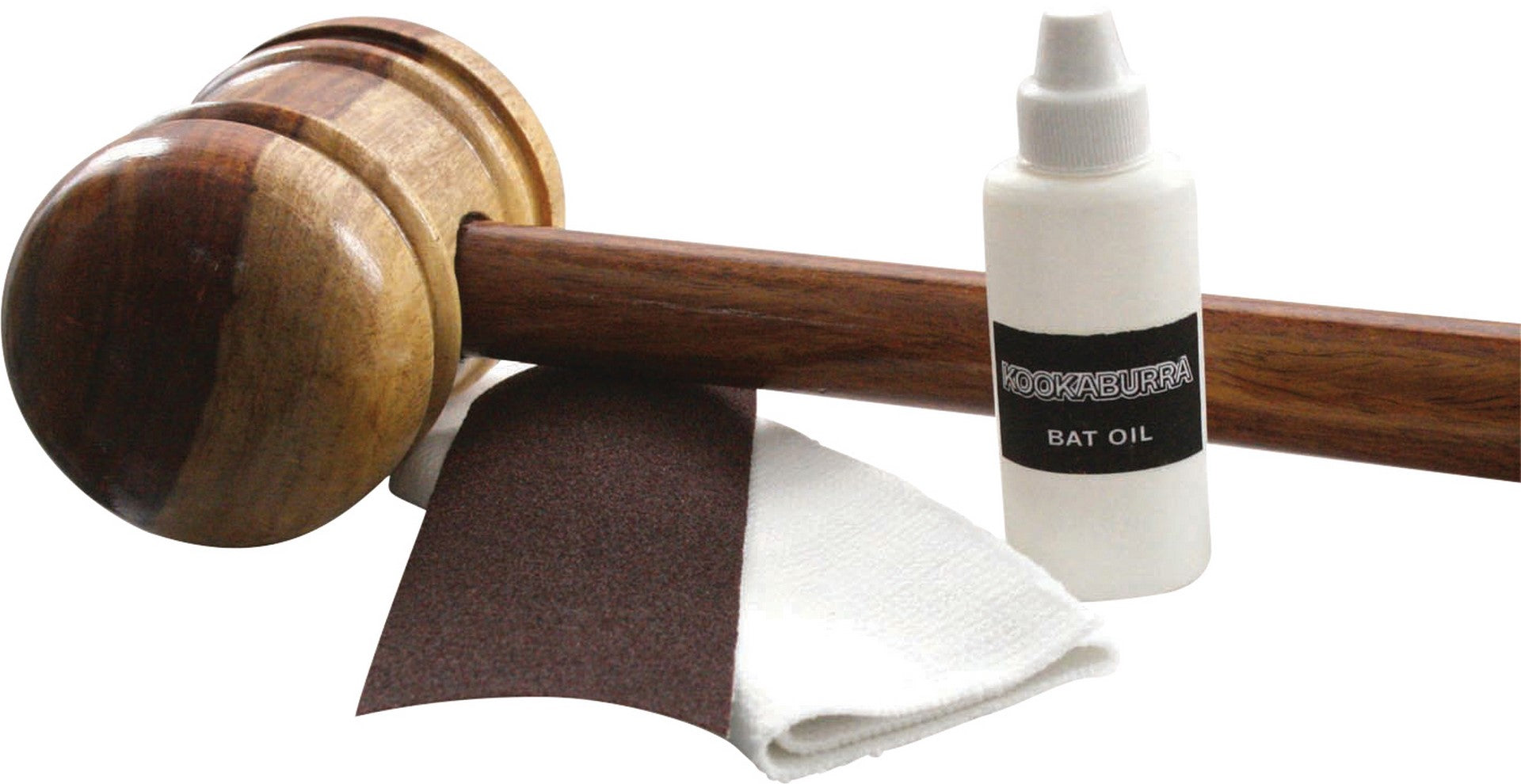 The Kookaburra Cricket Bat Care Kit by Kookaburra, including a wooden bat mallet, linseed bat oil, sandpaper, and a white cloth, is displayed on a white background.