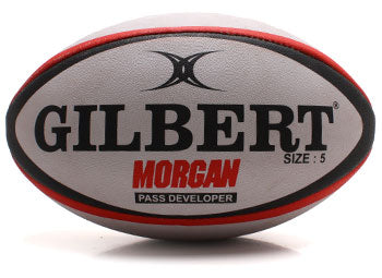 The Gilbert Morgan Rugby Pass Developer by Gilbert is a size 5 rugby ball with a gray surface, black and red accents, and bold lettering, designed to enhance passing skills and shown against a white background.
