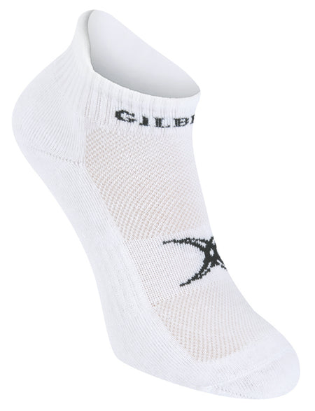 The Gilbert Netball Ankle Sock by Gilbert is a white ankle sock with a black logo on top, ribbed cuff, and elastic mid foot support, shown against a plain white background.