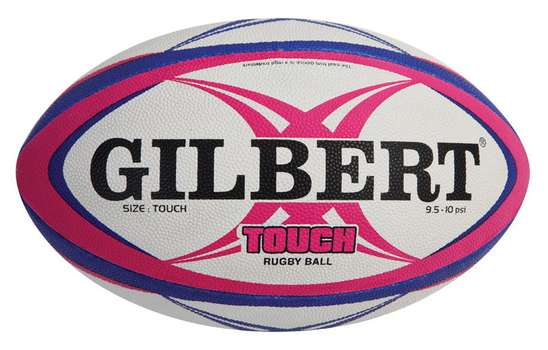 The Gilbert Touch Rugby Ball is a white ball with blue and pink curved stripes, featuring "GILBERT" in bold black letters and "TOUCH RUGBY BALL" in pink and black—ideal for training.