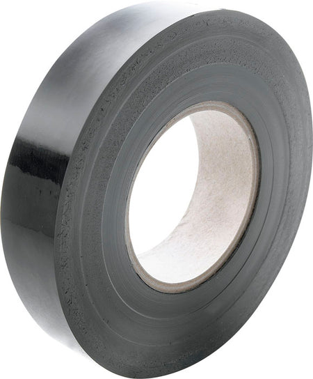 A roll of Gilbert Wondertape by Gilbert, black electrical tape with a cardboard core, is shown at an angle on a plain white background.