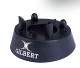 The Gilbert 450 Precision Kicking Tee is a black kicking tee from Gilbert, featuring four upright rubber prongs and a white Gilbert logo on the side, designed for accuracy on the pitch.