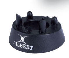 The Gilbert 450 Precision Kicking Tee is a black kicking tee from Gilbert, featuring four upright rubber prongs and a white Gilbert logo on the side, designed for accuracy on the pitch.