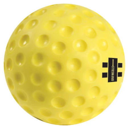 The Gray Nicolls Bowling Machine Ball is a bright yellow PVC ball with evenly spaced dimples and a small black rectangular Gray Nicolls logo, perfect for use with bowling machines.